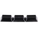 A row of black Fineline Tiny Temptations rectangular sectional trays with a white border.
