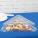 A Fineline clear plastic triangular tray dome lid over food