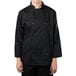 A person wearing a Mercer Culinary black long sleeve chef coat.