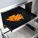 A Solwave solid tray of french fries cooking in a high speed oven.