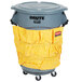 A grey Rubbermaid BRUTE trash can with a yellow liner and caddy bag.