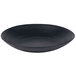 A black stoneware pasta plate with a wavy texture.