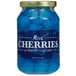 A jar of dark blue maraschino cherries with stems.