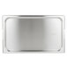 A Vollrath stainless steel rectangular pan cover with handles on a stainless steel tray.