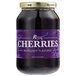 A jar of Regal Purple Maraschino Cherries with stems and a purple label.