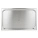 A Vollrath stainless steel rectangular pan cover on a stainless steel tray.