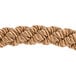 A close up of a braided bronze rope with gold ends.