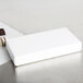 A white rectangular 2-piece candy box filled with chocolates on a white surface.