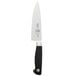 A Mercer Culinary Genesis forged chef knife with black handle.