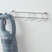 A white AvaMix handheld immersion blender wallhanger on a wall.