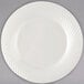 A Visions Wave ivory plastic plate with spiral lines.