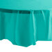 A teal lagoon octagonal plastic table cover on a round table.