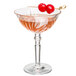 A Nachtmann cocktail glass with a drink and two cherries on it.