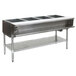 An Eagle Group stainless steel liquid propane steam table with four sealed wells on galvanized legs.