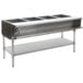 An Eagle Group stainless steel natural gas steam table with stainless steel legs over a counter.
