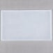 A white rectangular Flexsil lid on a gray surface.