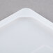 A white high-heat silicone lid on a white plastic tray.
