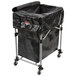 A black Rubbermaid laundry cart with black cover on wheels.