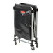 A black Rubbermaid laundry cart with wheels and a black cover.