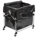A black Rubbermaid laundry cart on wheels with a cover.