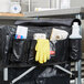 A black Rubbermaid bag filled with cleaning supplies on a counter.