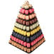 A pyramid of different colored macaroons on a Matfer Bourgeat black macaron display stand.