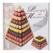 A black Matfer Bourgeat 9-tier pyramid display stand with stacks of macarons in different colors.