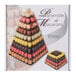 A Matfer Bourgeat clear pyramid display stand holding macarons.
