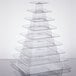 A clear plastic Matfer Bourgeat macaron pyramid display stand with a stack of trays.