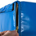 A hand opening a zipper on a blue Cres Cor bun pan rack cover bag.