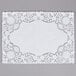A 10" x 14" white floral lace paper placemat with a white doily design.