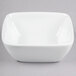 A Libbey white square bowl on a gray background.
