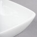 A close-up of a Libbey Aluma White Porcelain square bowl.