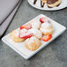 A Libbey aluma white porcelain tray with pastries and strawberries on it.