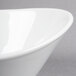 A close-up of a Libbey white porcelain bowl with a curved edge.