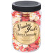 A jar of Grandma Jack's Gourmet Cherry Cheesecake Popcorn on a table.