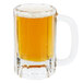 A Libbey glass beer mug filled with yellow liquid.