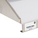 A close-up of a stainless steel wall mount shelf.