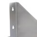 A close-up of a stainless steel microwave shelf with holes on the side.