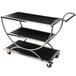 An Eastern Tabletop black and silver serving cart with stainless steel frame and reversible wood shelves.