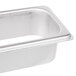 A Vollrath stainless steel rectangular tray with a hole in it.