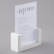 A white Cal-Mil U-frame tabletop menu holder with a stand.