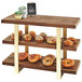 A wood shelf with food on it, including pastries and bagels.