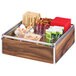 A Cal-Mil wooden condiment organizer with chrome accents holding a variety of condiments.