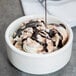 A bowl of ice cream with HERSHEY'S Special Dark Fudge Topping.