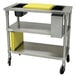 A stainless steel Advance Tabco chicken cutting station with a yellow rectangular block on top.