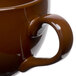 A close up of a Tuxton mahogany cappuccino cup with a handle.