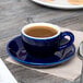 A blue Tuxton cappuccino cup of coffee on a saucer.