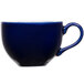A close-up of a blue coffee cup with a handle.