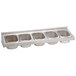 A silver stainless steel Advance Tabco bottle rack with four compartments.